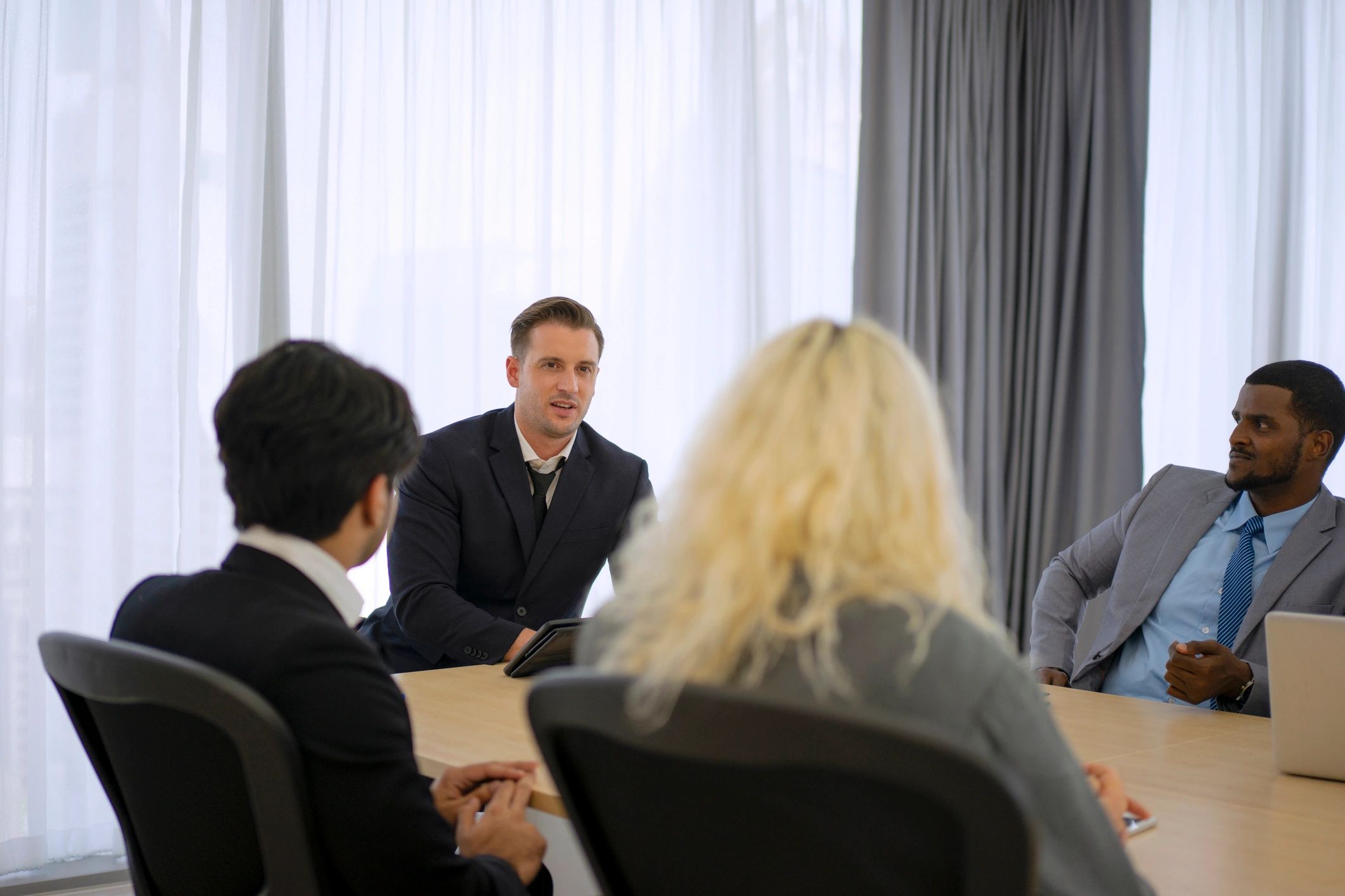 Reporters and staff meeting in a conference room