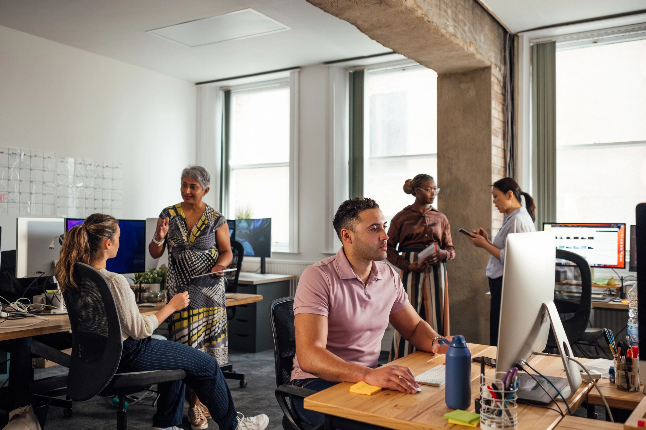 Journalists working together in a modern newsroom