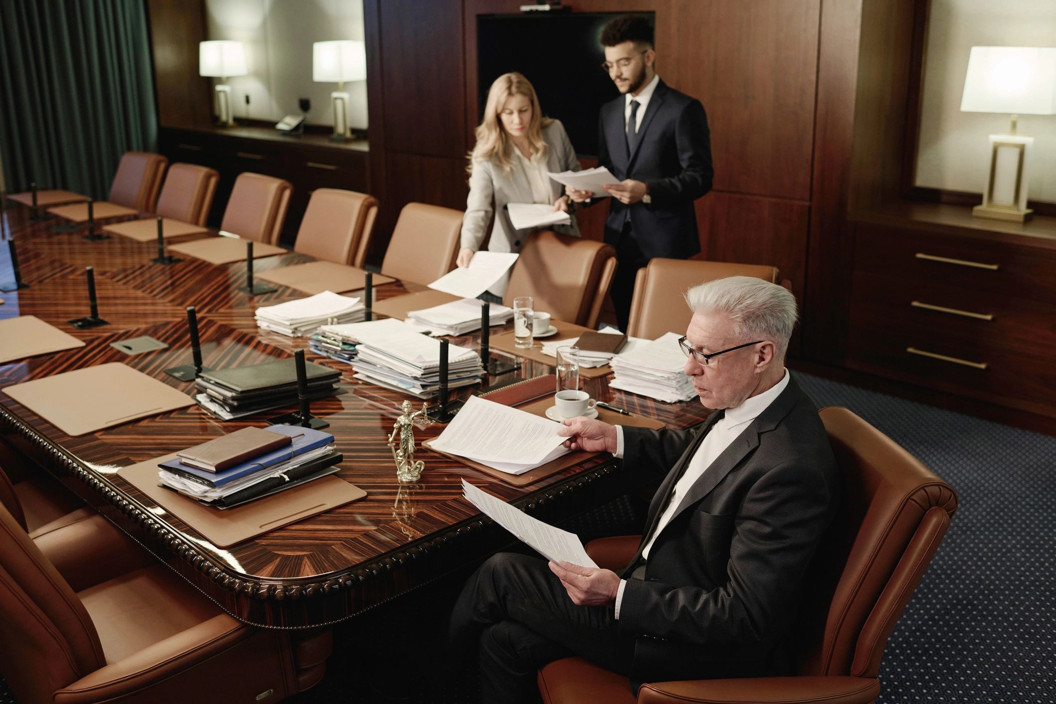 Journalists reviewing documents at a conference table